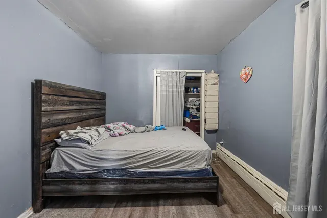 a bedroom with a bed and a dresser