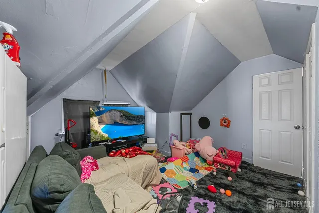a kitchen with sink cabinets and flat screen tv