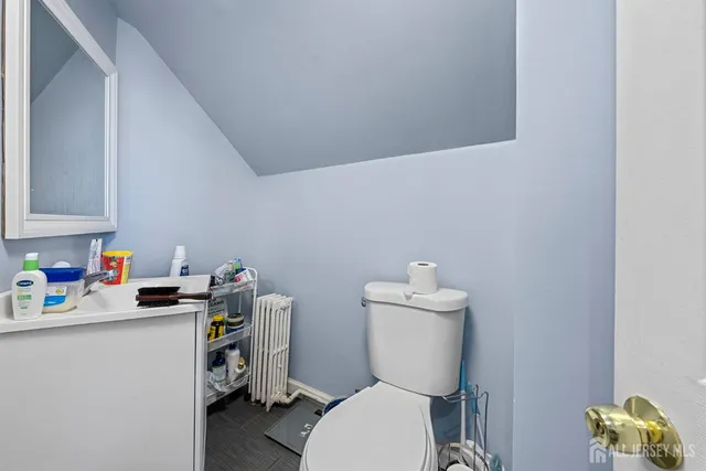 a bedroom with a bed and a mirror