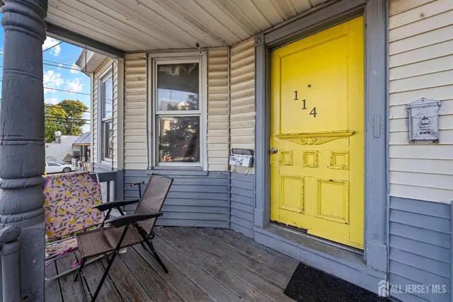 a front view of a building with a garden