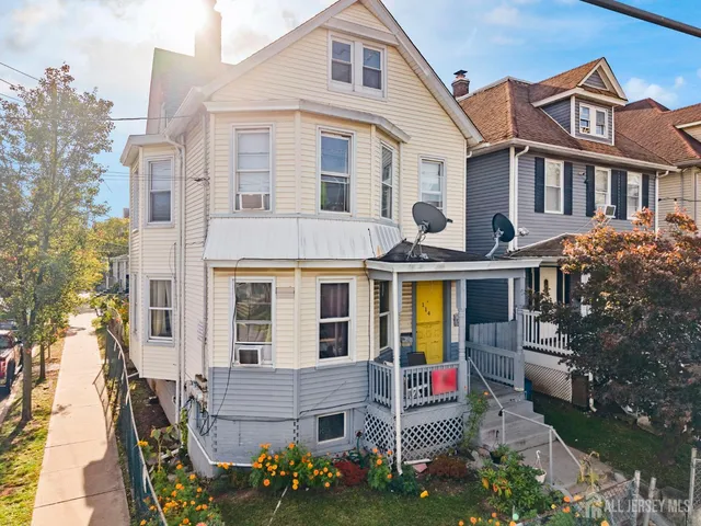 a view of a house with a yard and sitting area