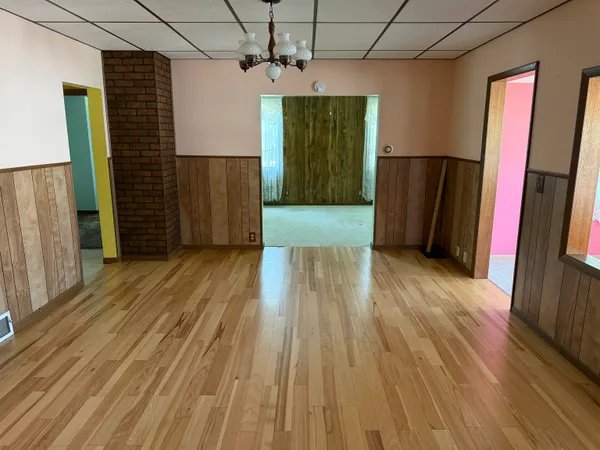 a view of a room with a wooden floor and a window