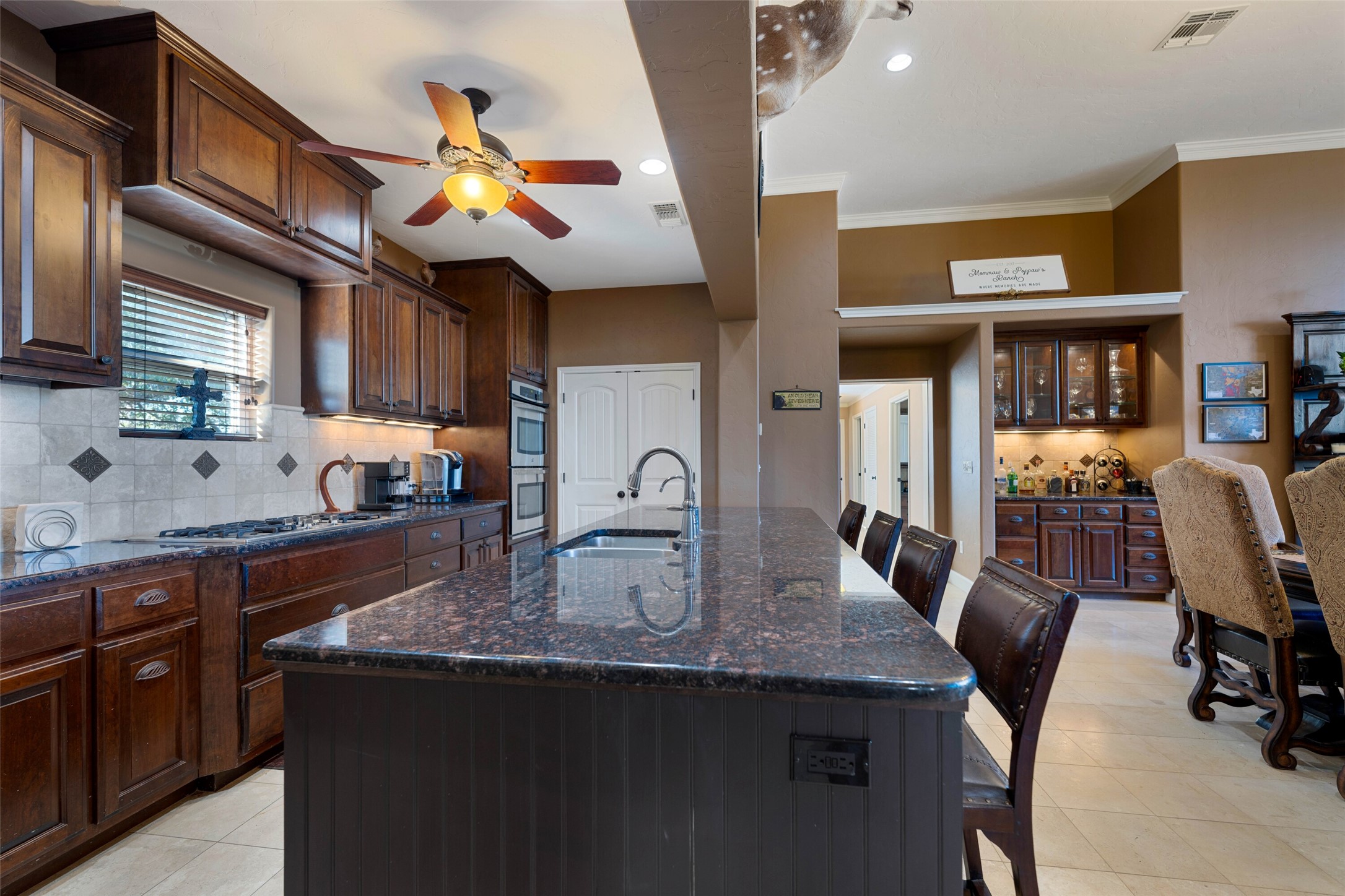 7702 Ranch Road 965 Llano, TX 78643 - Photo 7 of 40 a kitchen with stainless steel appliances granite countertop a stove a sink dishwasher and cabinets with wooden floor