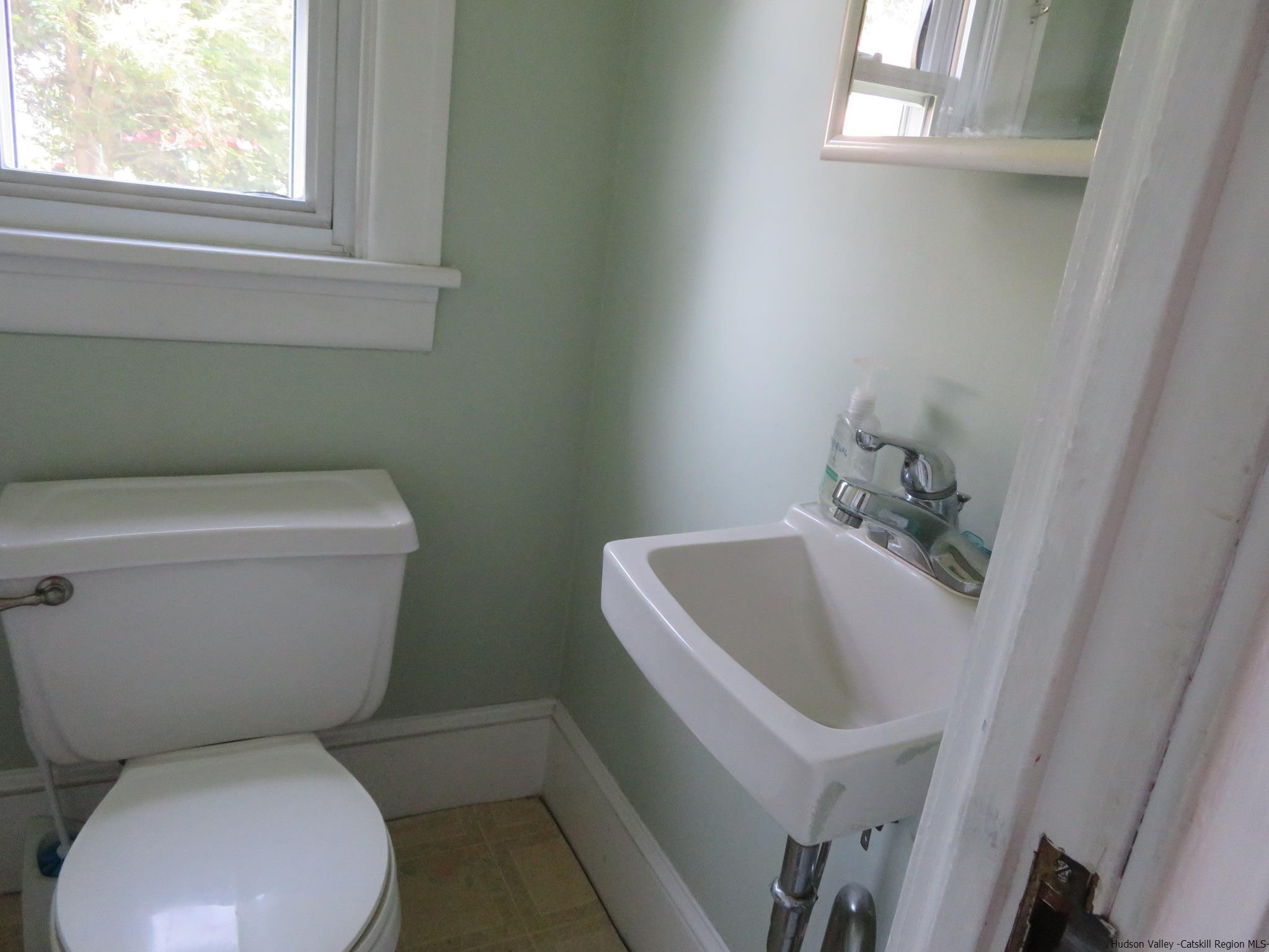 27 Pine Street Kingston, NY 12401 - Photo 11 of 32 a white toilet sitting next to a window