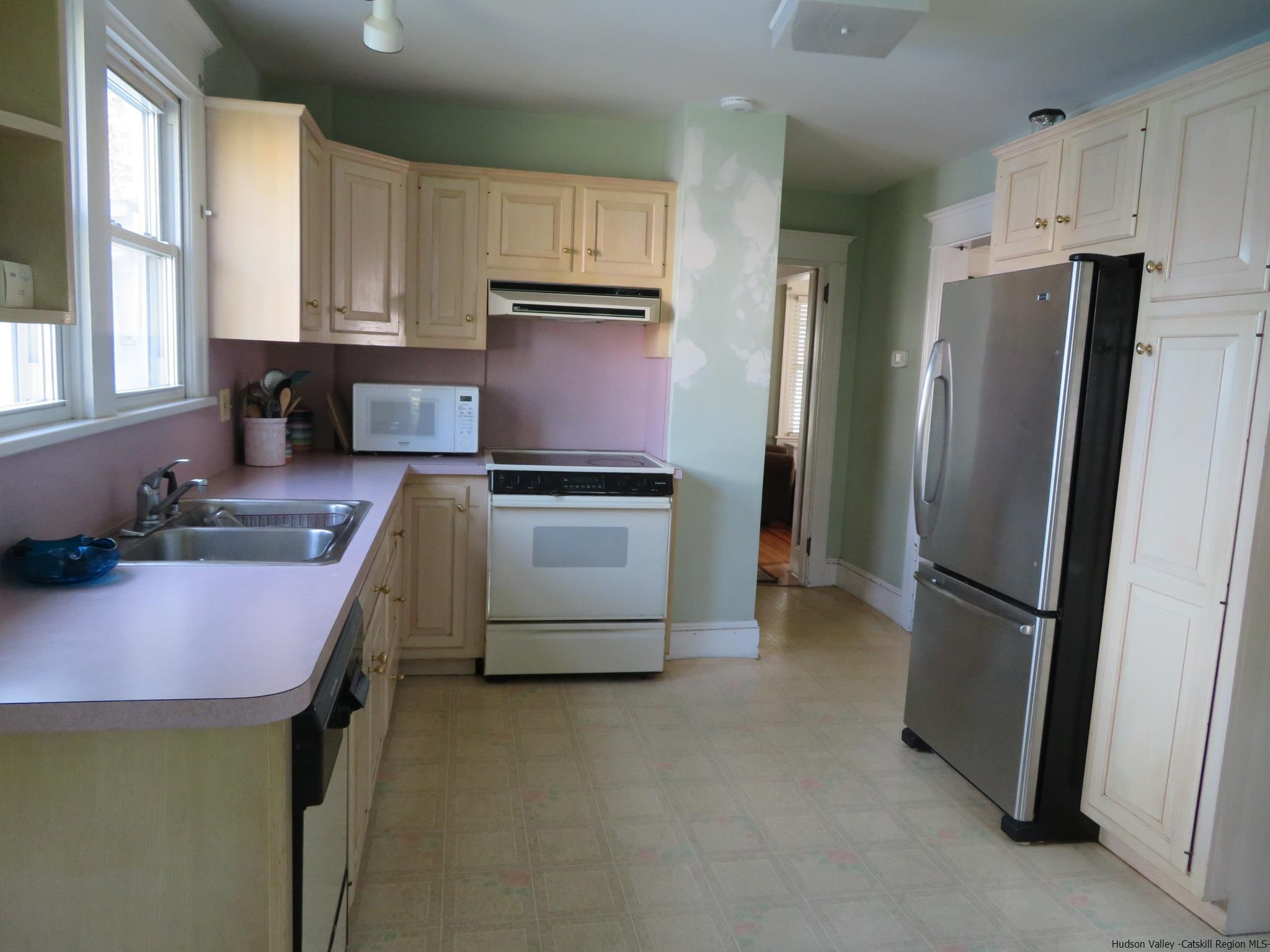27 Pine Street Kingston, NY 12401 - Photo 12 of 32 a kitchen with stainless steel appliances granite countertop a refrigerator sink and stove