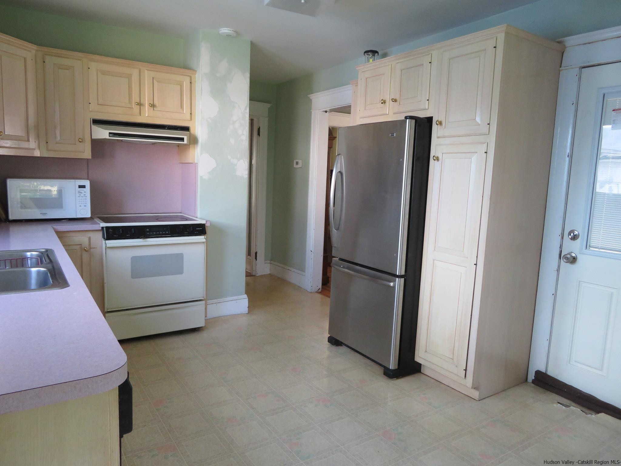 27 Pine Street Kingston, NY 12401 - Photo 13 of 32 a kitchen with stainless steel appliances granite countertop a refrigerator a microwave a sink and a stove