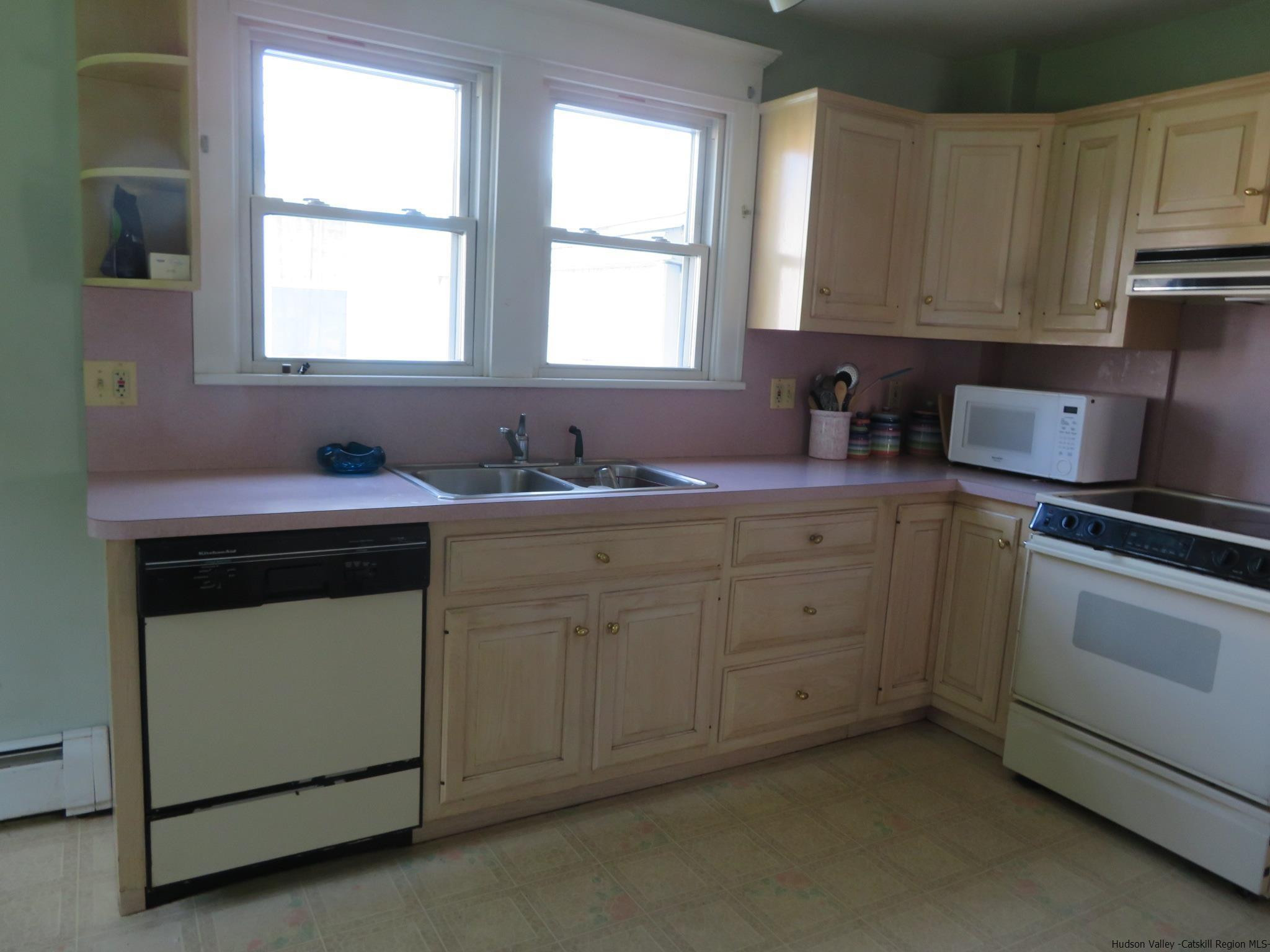27 Pine Street Kingston, NY 12401 - Photo 14 of 32 a kitchen with cabinets appliances a sink and a window