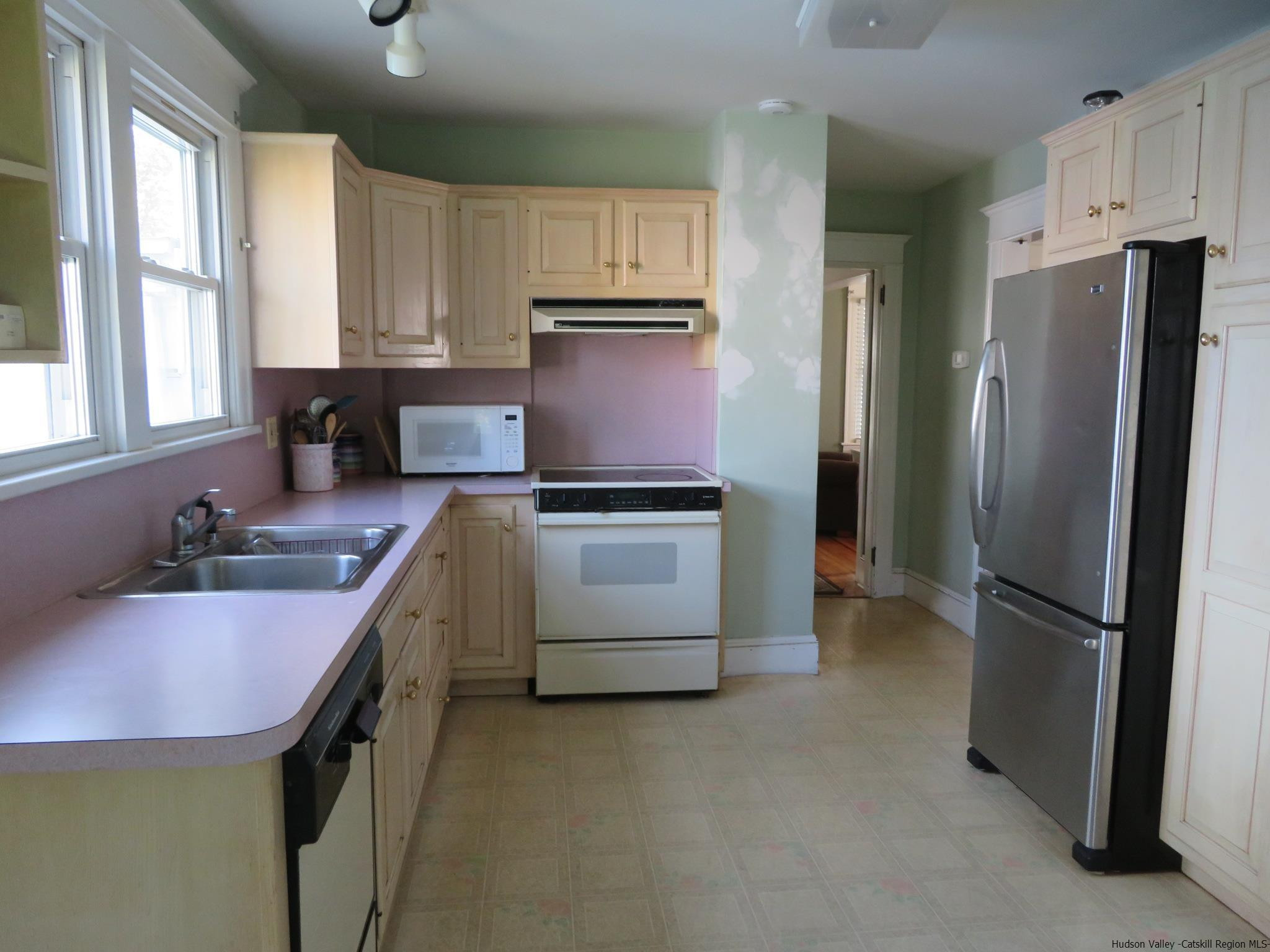 27 Pine Street Kingston, NY 12401 - Photo 17 of 32 a kitchen with kitchen island a sink appliances and cabinets