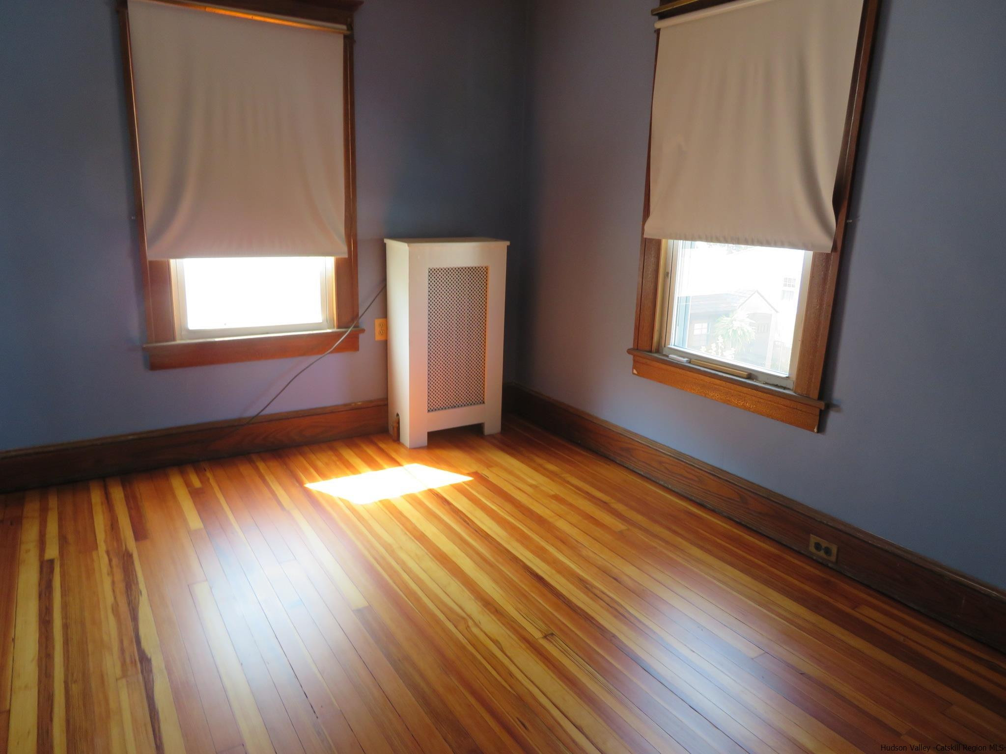 27 Pine Street Kingston, NY 12401 - Photo 20 of 32 an empty room with wooden floor and windows