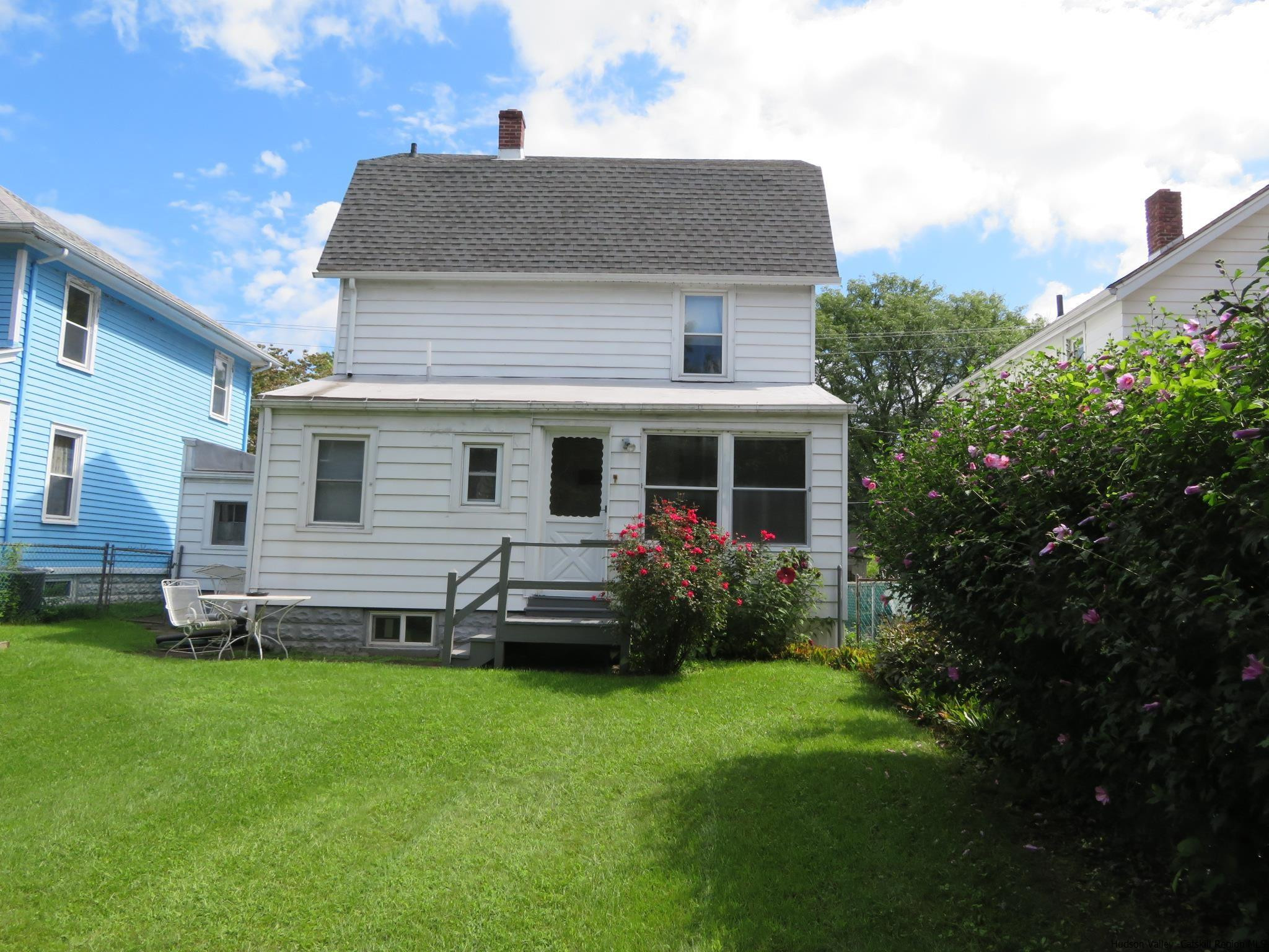 27 Pine Street Kingston, NY 12401 - Photo 3 of 32 a front view of a house with a garden and yard