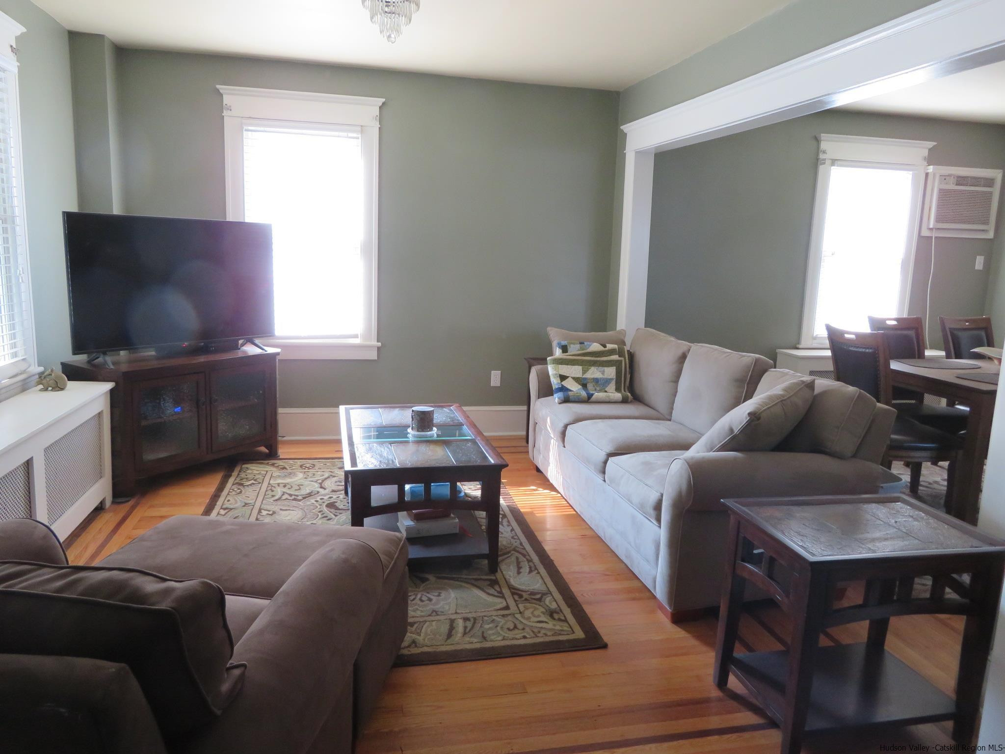 27 Pine Street Kingston, NY 12401 - Photo 8 of 32 a living room with furniture a flat screen tv and a window