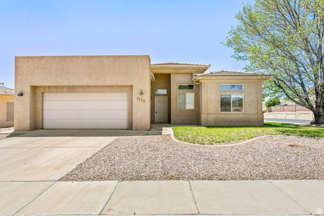2226 East 140 South St. George, UT 84790 - Photo 1 of 20 Stucco exterior featuring an attached garage and a covered entryway