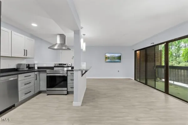 a kitchen with stainless steel appliances granite countertop a stove a sink and a refrigerator