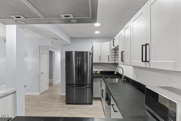 a kitchen with stainless steel appliances a refrigerator and a sink