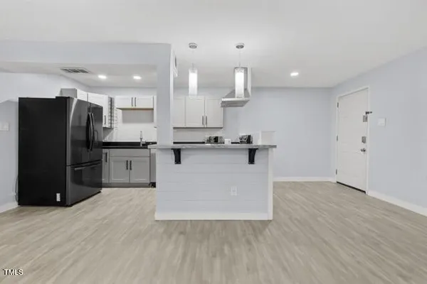 a kitchen with stainless steel appliances a refrigerator and a sink