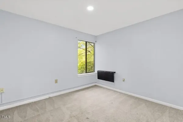 an empty room with windows and natural light