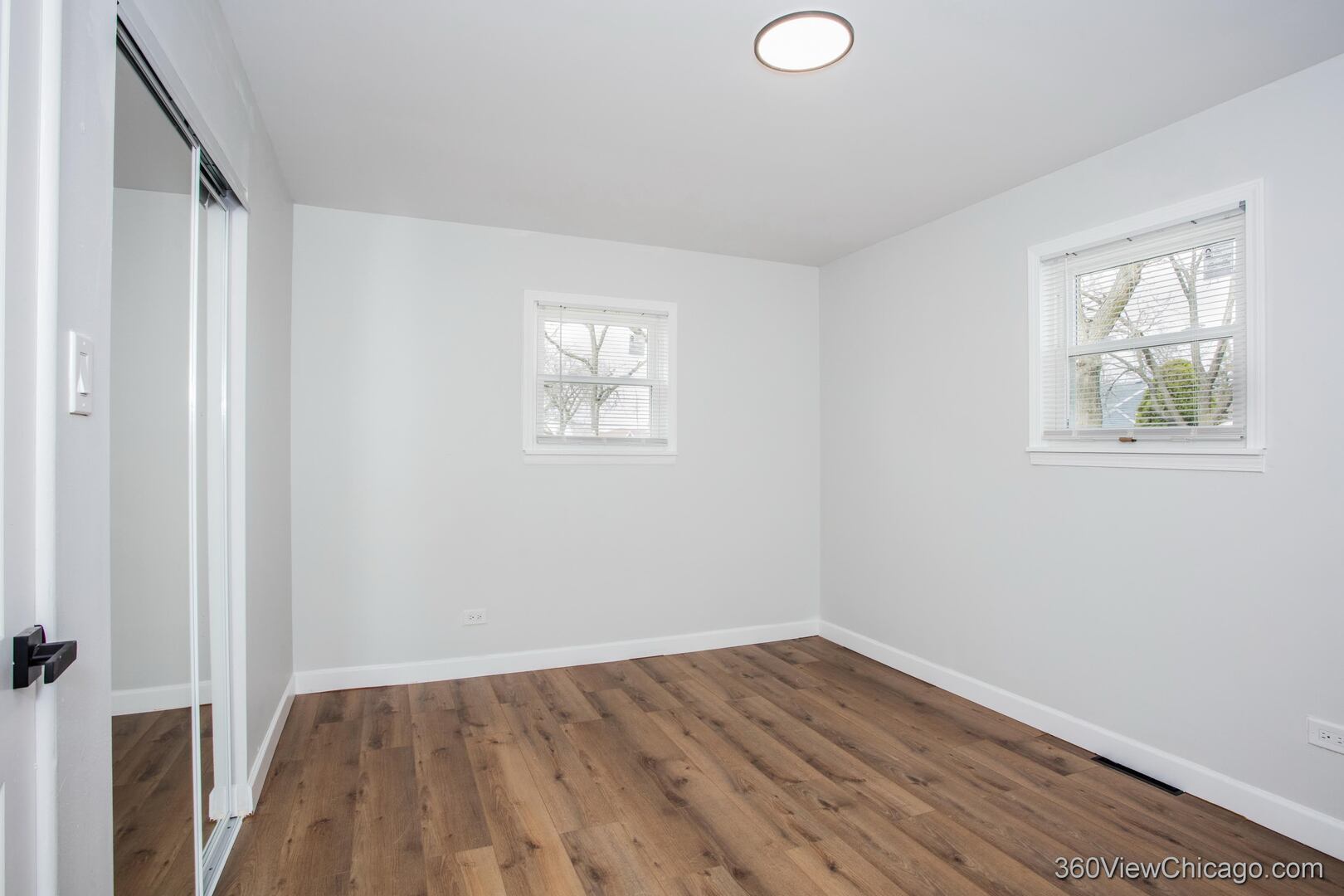 8651 44th Street Lyons, IL 60534 - Photo 11 of 31 an empty room with wooden floor and windows