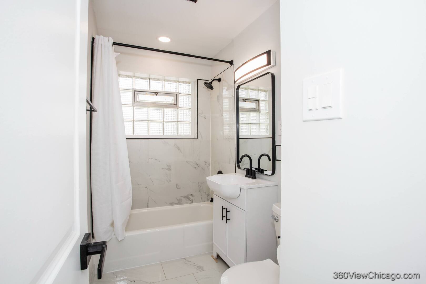 8651 44th Street Lyons, IL 60534 - Photo 14 of 31 a bathroom with a sink toilet and shower
