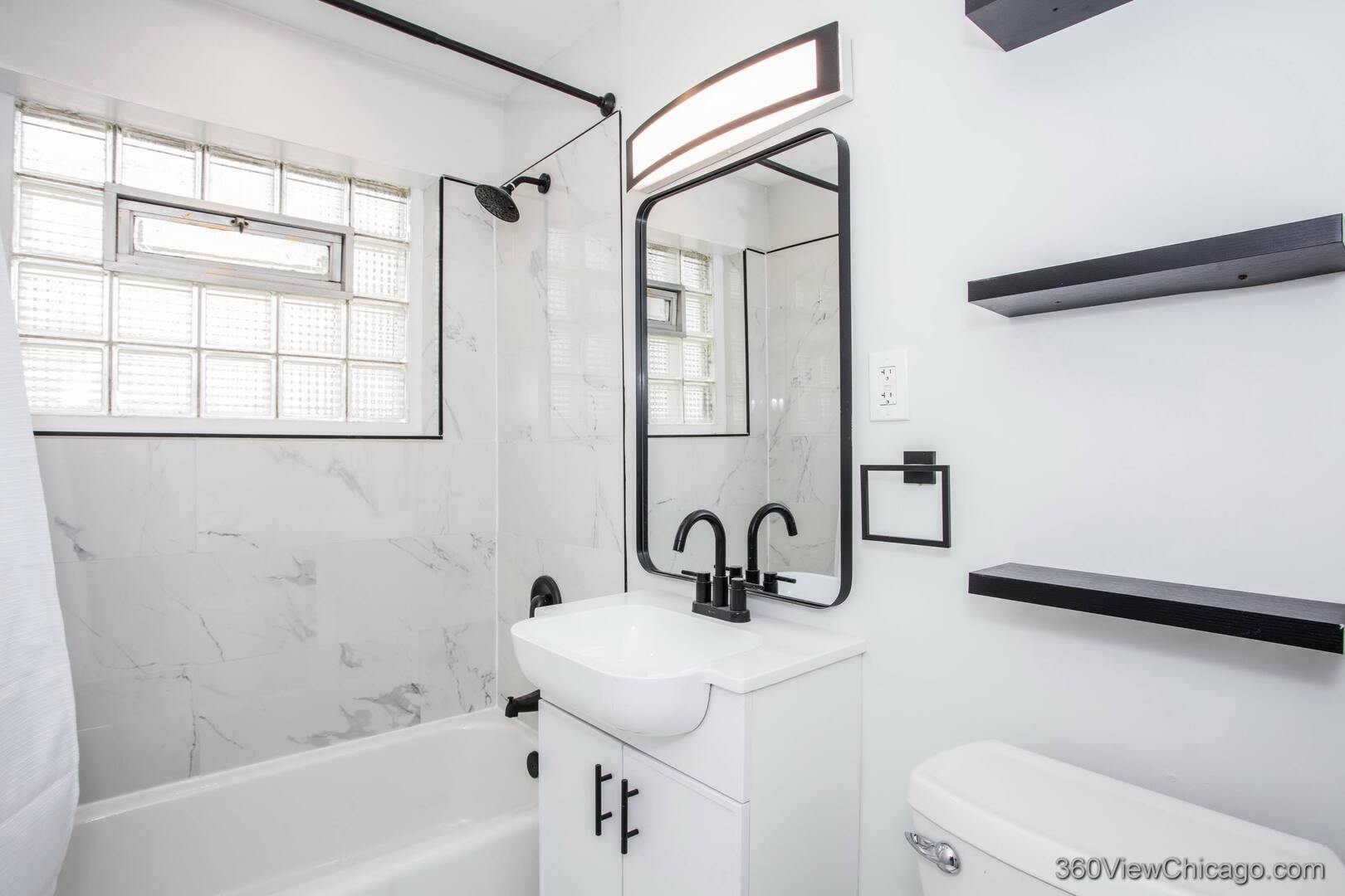 8651 44th Street Lyons, IL 60534 - Photo 16 of 31 a bathroom with a sink a toilet and shower