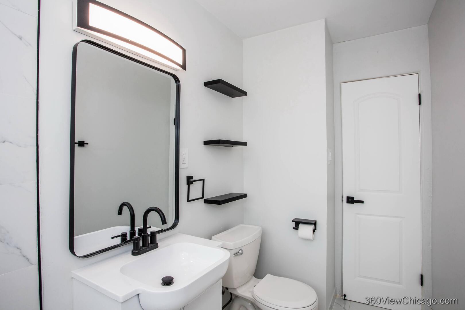 8651 44th Street Lyons, IL 60534 - Photo 17 of 31 a bathroom with a toilet sink and a mirror