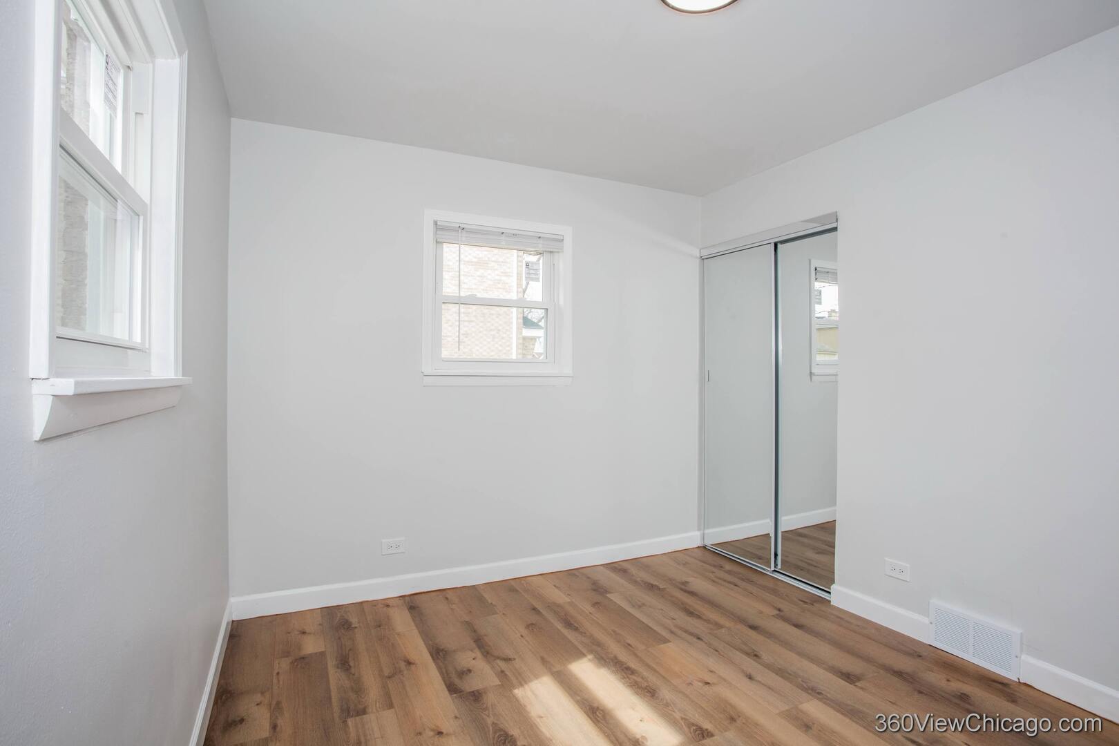 8651 44th Street Lyons, IL 60534 - Photo 20 of 31 a view of an empty room with wooden floor and a window