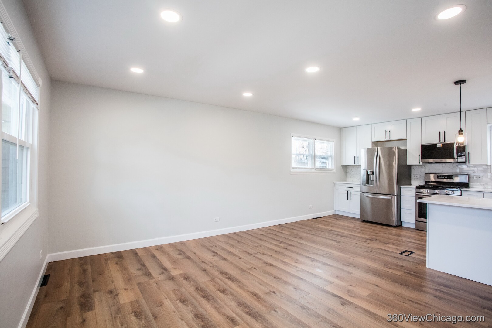 8651 44th Street Lyons, IL 60534 - Photo 7 of 31 a view of kitchen with wooden floor electronic appliances and window