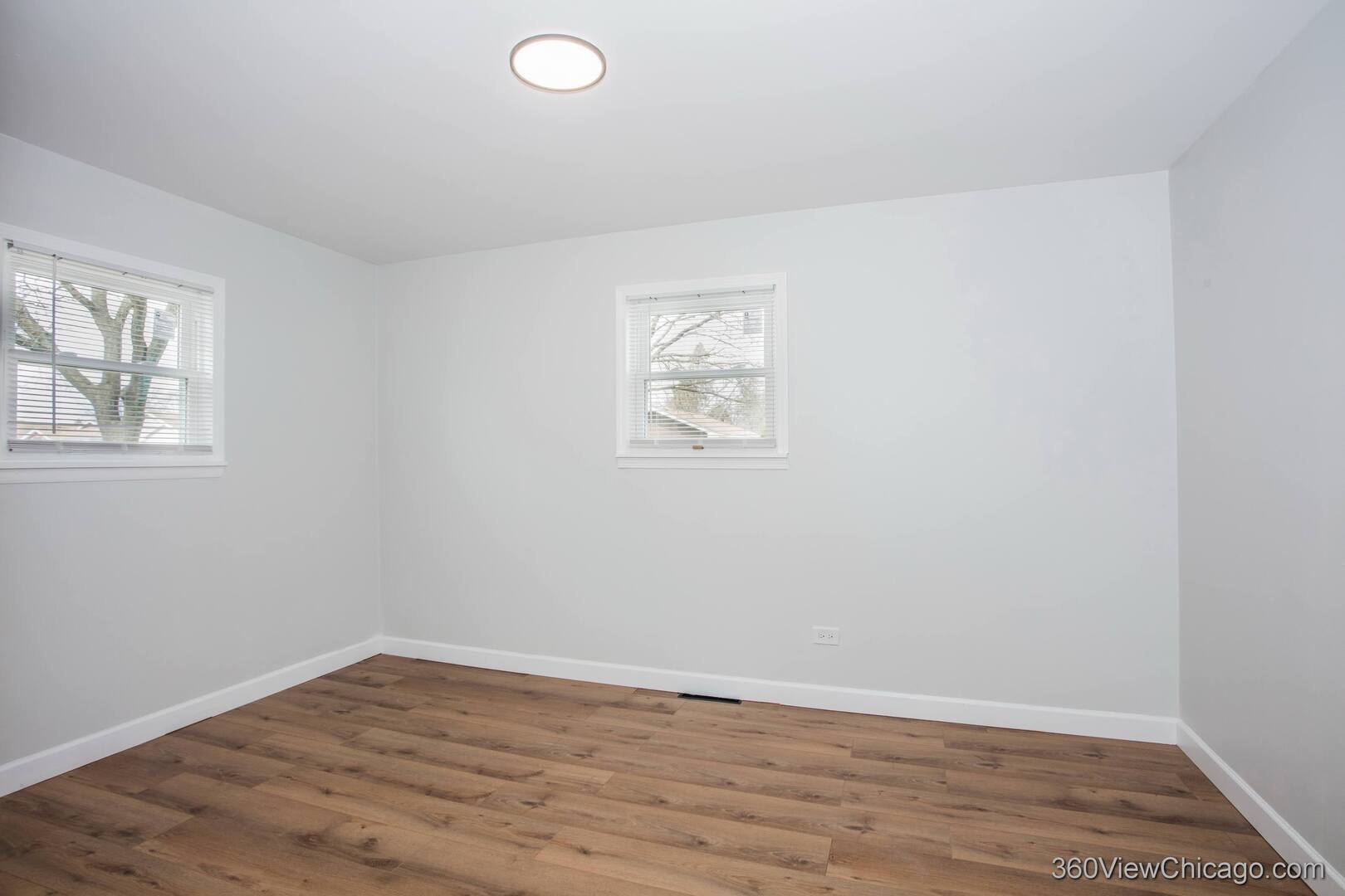 8651 44th Street Lyons, IL 60534 - Photo 10 of 31 an empty room with wooden floor and windows