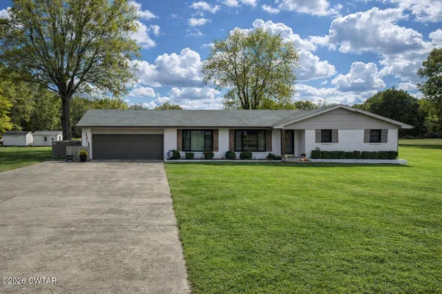 a front view of house with yard and green space