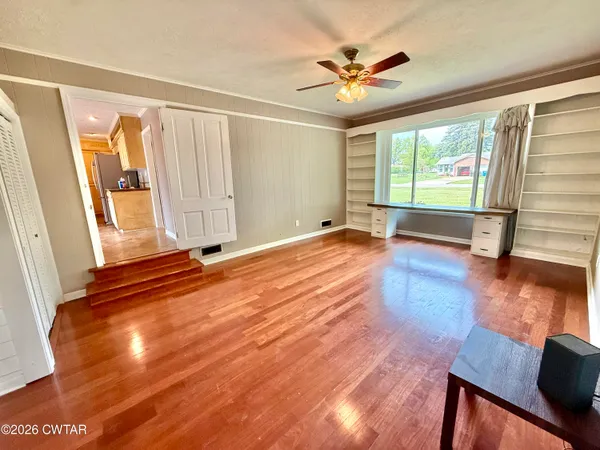 a view of an empty room with a fireplace