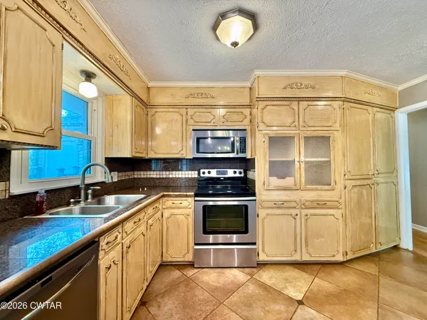 a view of a livingroom with kitchen and dining area wooden floor kitchen view