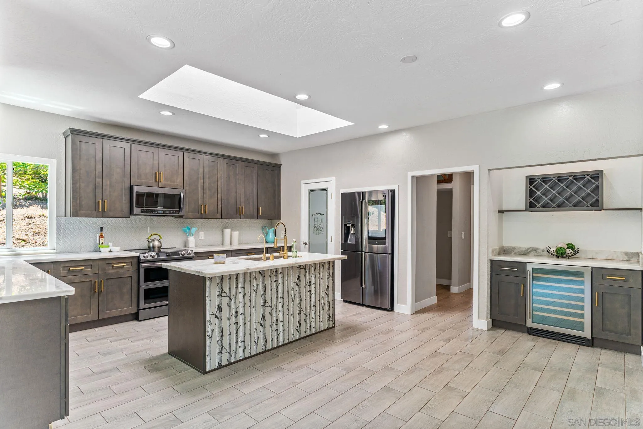 29575 Costalota Road Valley Center, CA 92082 - Photo 11 of 39 a kitchen with stainless steel appliances granite countertop a stove top oven a refrigerator a sink and dishwasher