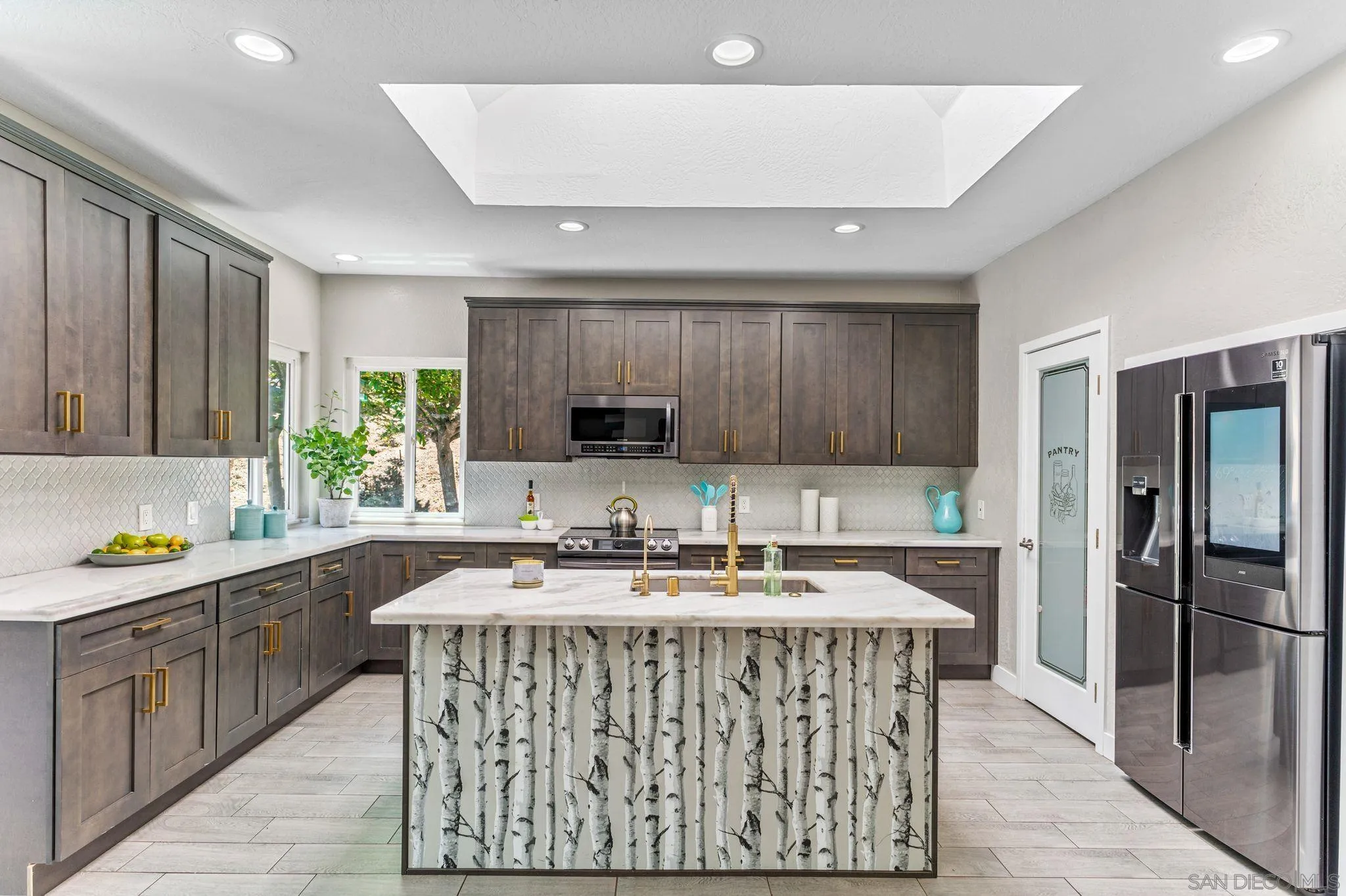 29575 Costalota Road Valley Center, CA 92082 - Photo 9 of 39 a kitchen with a sink stove and cabinets