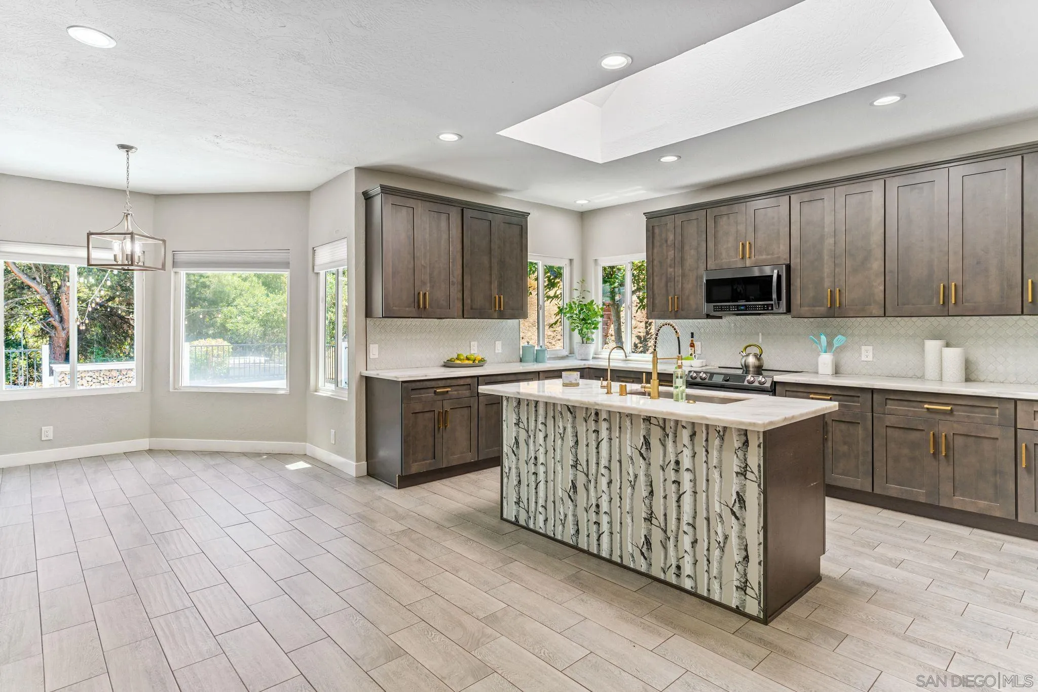 29575 Costalota Road Valley Center, CA 92082 - Photo 10 of 39 a kitchen with stainless steel appliances granite countertop a stove top oven a sink dishwasher and a microwave oven with cabinets