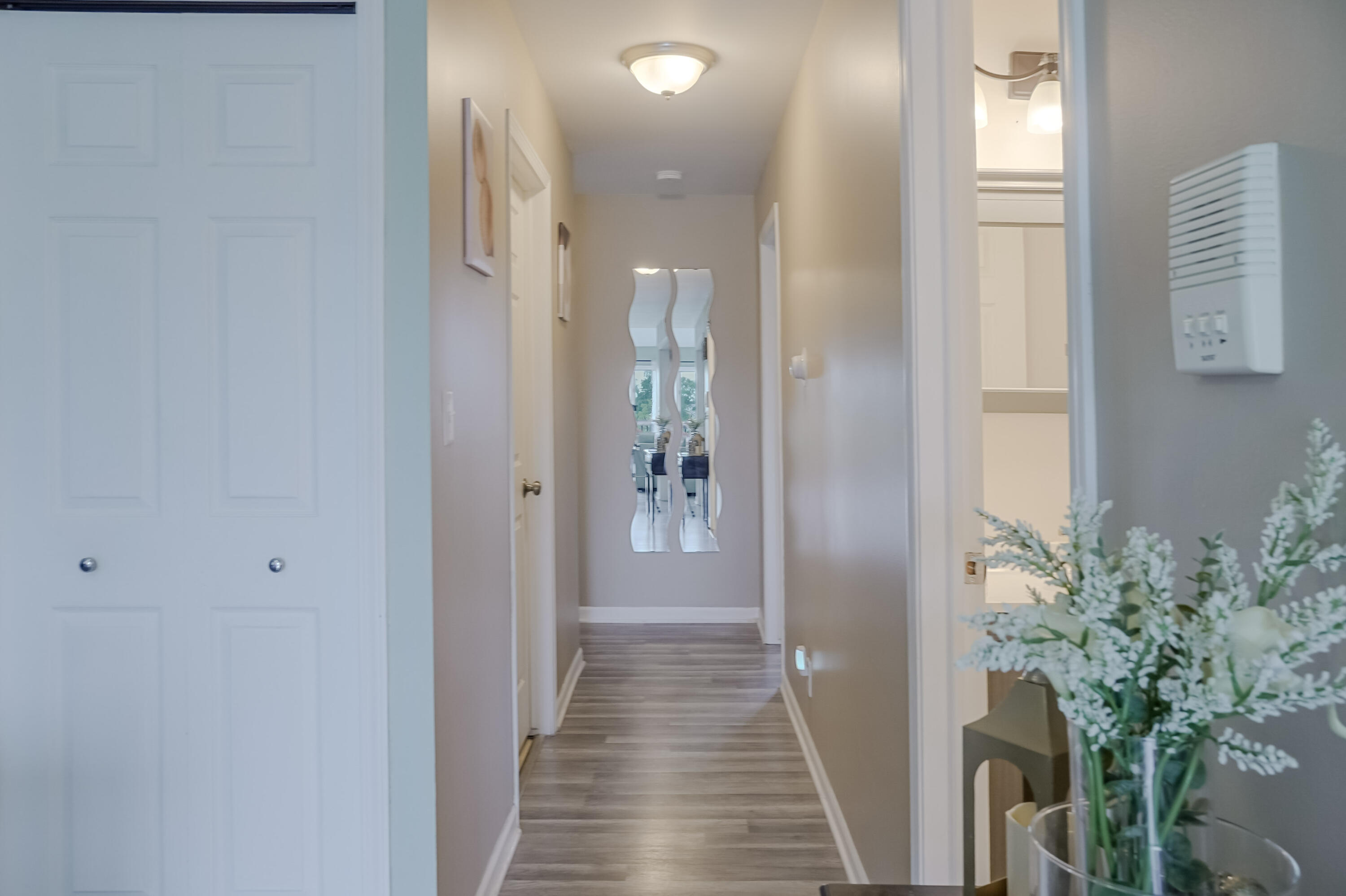 5065 Spinnaker Lane, Unit E Crown Point, IN 46307 - Photo 15 of 43 a view of a hallway with wooden floor and a bathroom