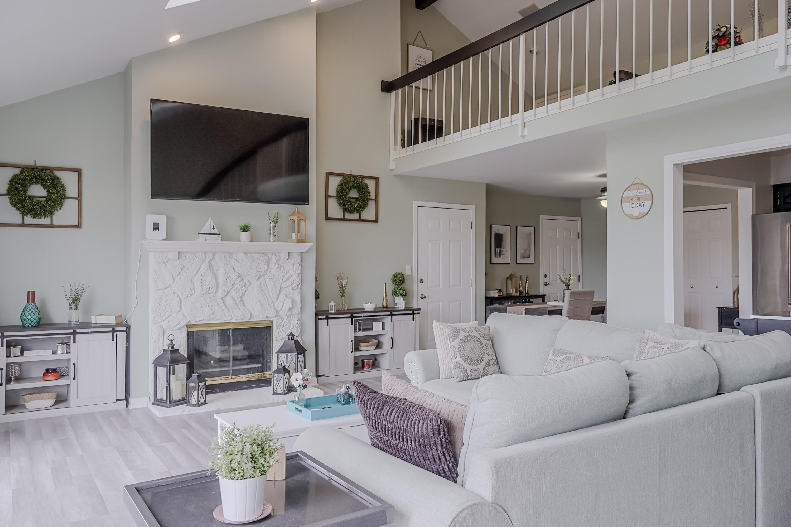 5065 Spinnaker Lane, Unit E Crown Point, IN 46307 - Photo 2 of 43 a living room with furniture a flat screen tv and a fireplace