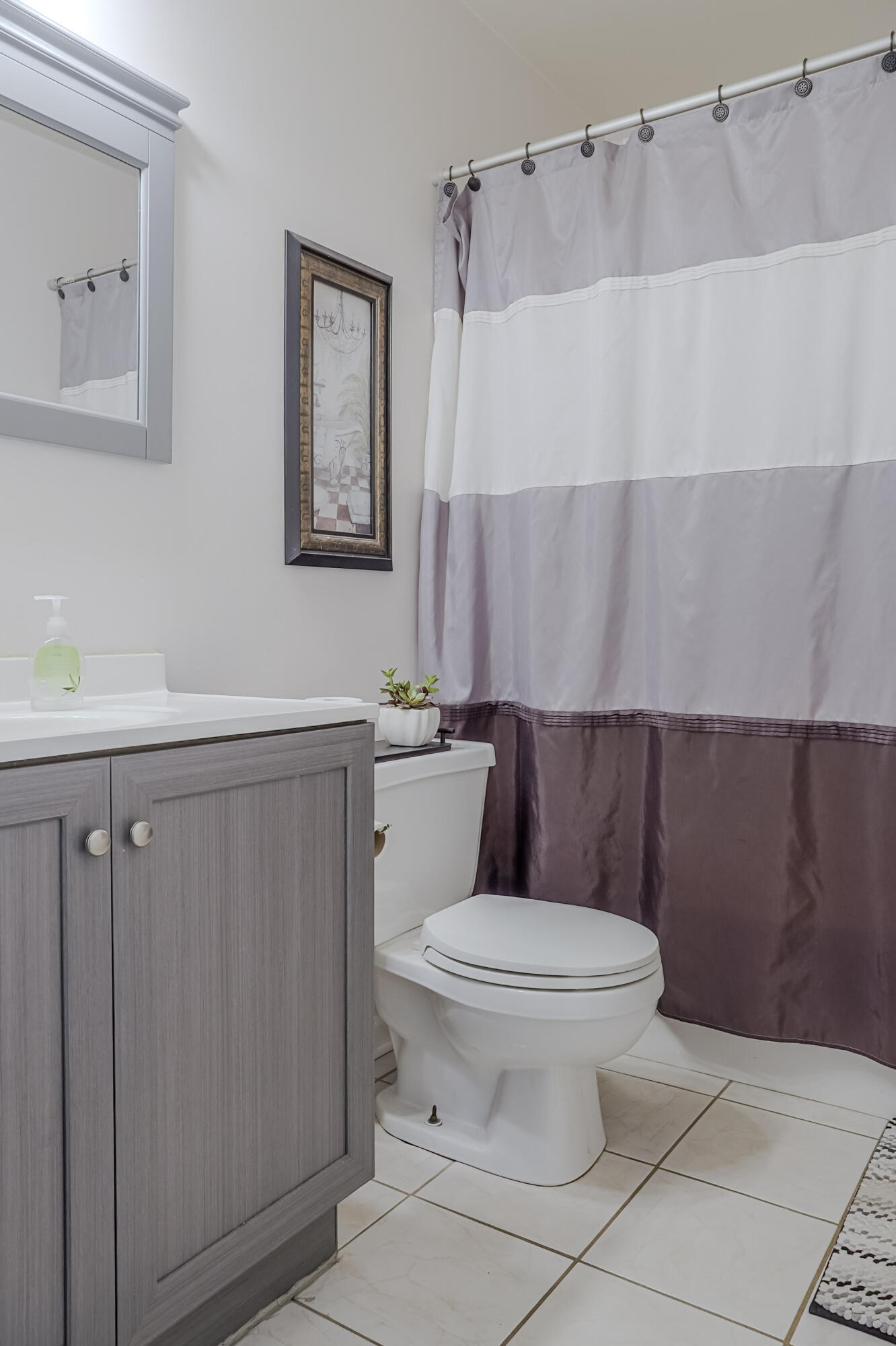 5065 Spinnaker Lane, Unit E Crown Point, IN 46307 - Photo 26 of 43 a white toilet sitting next to a bathroom sink