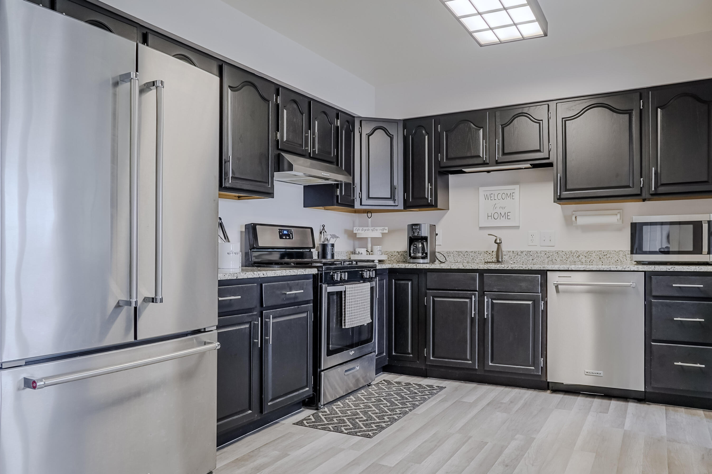 5065 Spinnaker Lane, Unit E Crown Point, IN 46307 - Photo 3 of 43 a kitchen with stainless steel appliances granite countertop a refrigerator stove and sink