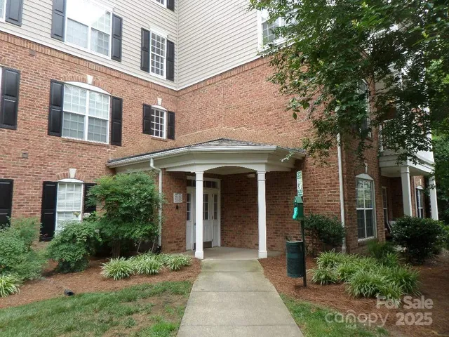a front view of a house with garden and plants