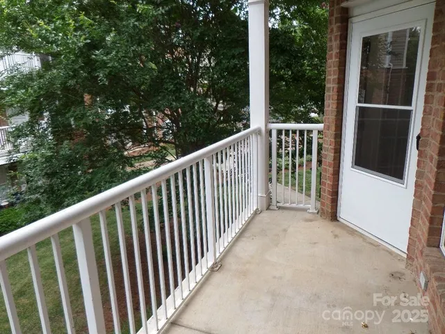 a view of a balcony with yard