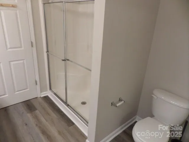 a bathroom with a toilet and a shower