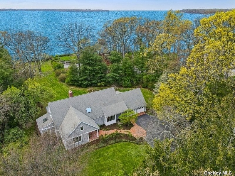 an aerial view of a house with yard and outdoor seating