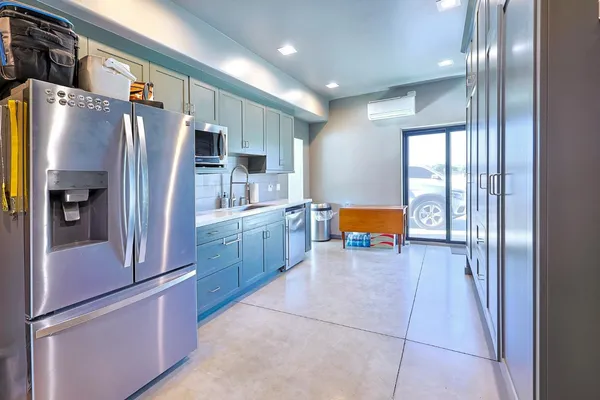 a kitchen with stainless steel appliances granite countertop a sink and cabinets