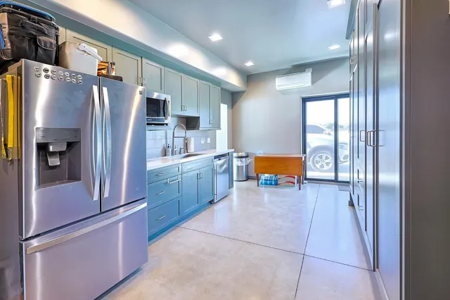 a kitchen with stainless steel appliances granite countertop a sink and cabinets