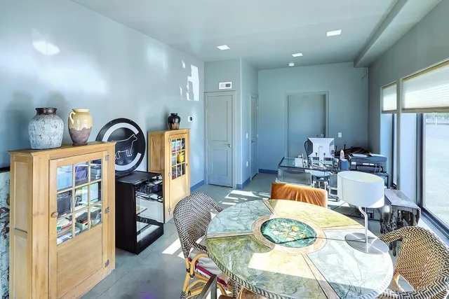 a living room with furniture and a floor to ceiling window