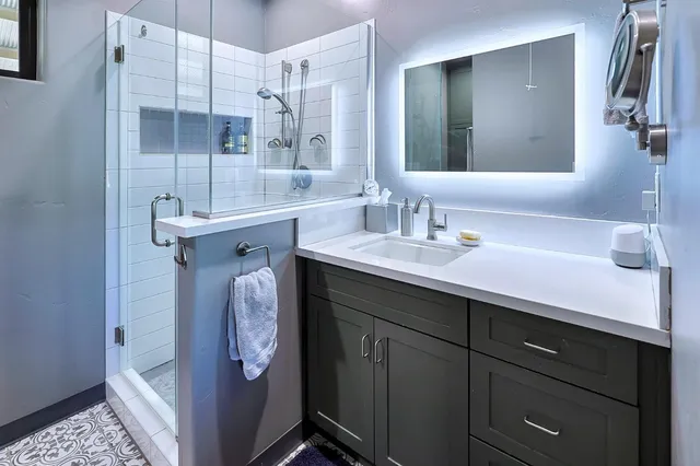 a bathroom with a sink a vanity and a mirror
