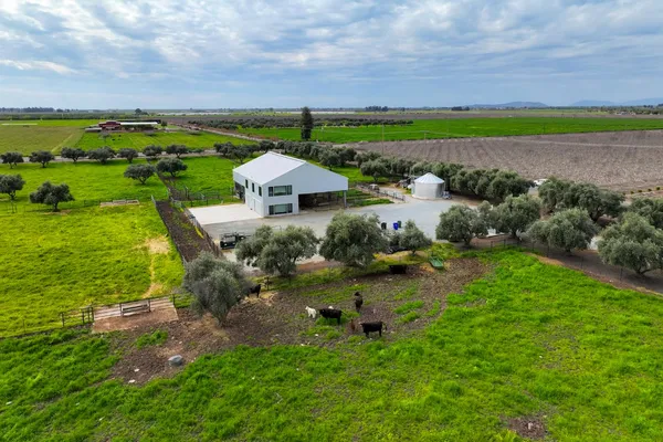 an aerial view of a house with garden space and outdoor seating
