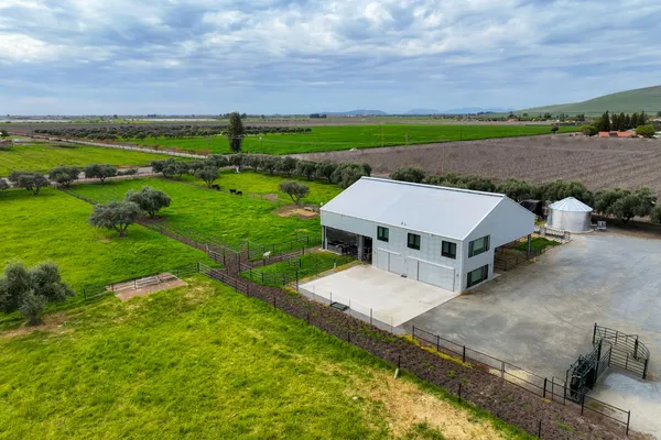 an aerial view of a house with big yard