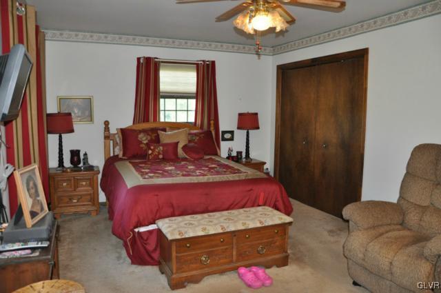 3532 High Hill Road Effort, PA 18330 - Photo 10 of 24 a bedroom with a bed and a chandelier