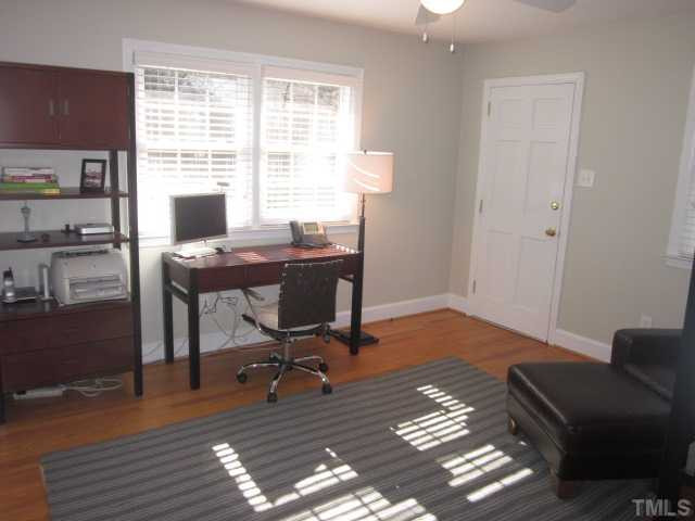 2031 Reaves Drive Raleigh, NC 27608 - Photo 19 of 25 This is one of the secondary bedrooms currently being used as an office! The door leads outside to the back yard area! Bedroom features ceiling fan with light kit, data ports, wall mount for TV and full bathroom! Bedroom