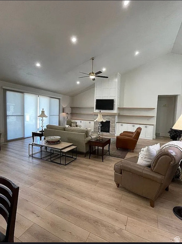 838 East Mountain Road North Ogden, UT 84414 - Photo 7 of 37 Spacious living area featuring wood-finish flooring, a vaulted ceiling with recessed lighting and a ceiling fan, and large sliding doors